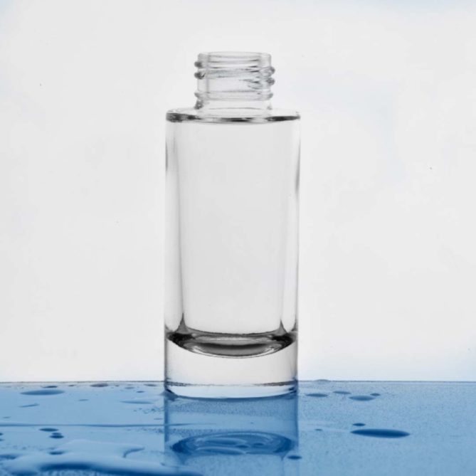 A glass cosmetic bottle in a bathroom
