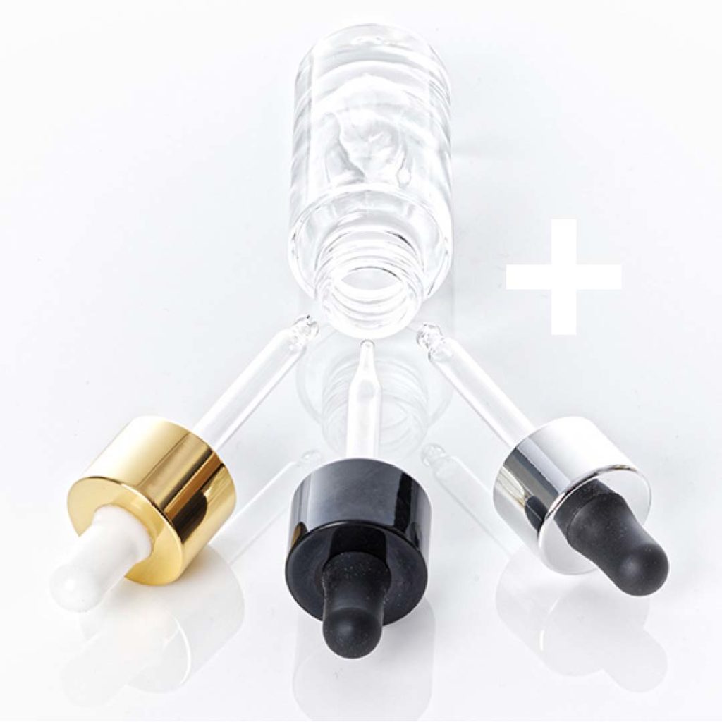 A glass cosmetic bottle with three droppers: gold, black and silver