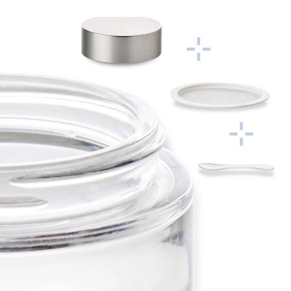 glass cosmetic jar with its metal lid, its lid and its spatula